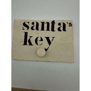 "santa's key" wooden plaque with  a small knob to hang key